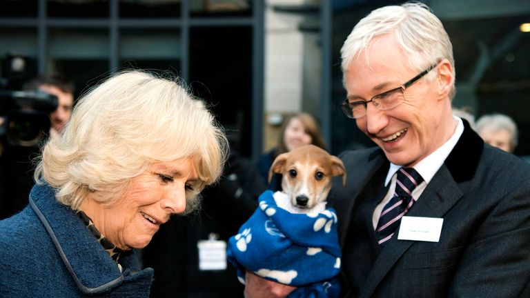 The Duchess of Cornwall (L) speaks with television presenter Paul O&#39;Grady (R) during a visit to Battersea Dogs & Cats Home where she met staff and volunteers in London on December 12, 2012. Earlier in the year The Duchess re homed Bluebell, a nine-week-old Jack Russell Terrier, after she was found as a stary wandering in a London park. Her Royal Highness adopted Beth, a Jack Russell Terrier puppy, from Battersea Dogs & Cats Home in August 2011. In September of this year, The Duchess adopted a second Jack Russell Terrier puppy from Battersea, called Bluebell. Established in 1860, Battersea Dogs & Cats Home aims never to turn away a dog or cat in need of its help.  The charity reunites lost dogs and cats with their owners or cares for them until new homes can be found for them, giving them shelter and the highest standards of kennelling and veterinary care. In 2011 the Home cared for almost 6,000 dogs and 3,000 cats across its three centres in South West London, Old Windsor, Berkshire and Brands Hatch, Kent. In its 152 year history Battersea has rescued, reunited and rehomed over 3.1 million dogs and cats. Today the charity rehomes dogs and cats across the UK and overseas. It takes an average of 45 days to find a new home for a dog and 28 days for a cat, and there is no time limit on how long an animal can stay at the Home. AFP PHOTO / ADRIAN DENNIS / WPA POOL