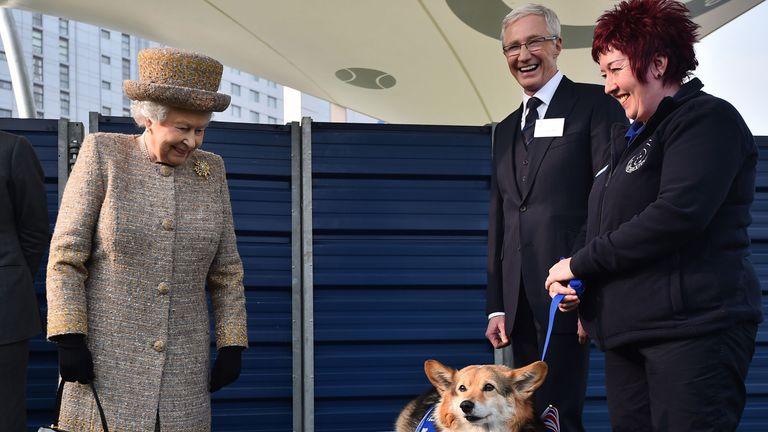 File photo dated 17/03/15 of Queen Elizabeth II looking at a Corgi as Paul O&#39;Grady looks on during a visit to Battersea Dogs and Cats Home in London. 
