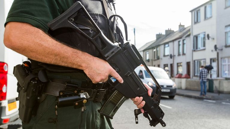 PSNI officers and Army technical officers search properties on Old Glenarm Road in Larne, Co Antrim. A Royal Marine is being questioned by detectives investigating Northern Ireland-linked terrorism, understood to be connected to two major dissident republican arms finds.