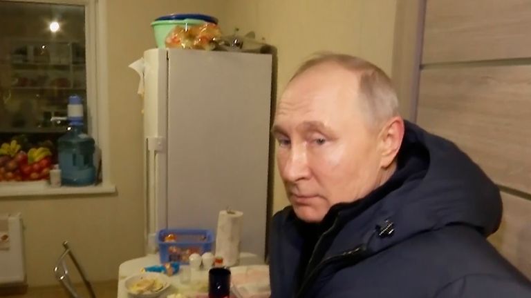 In this photo taken from video released by Russian TV Pool on Sunday, March 19, 2023, Russian President Vladimir Putin listens to local residents at their new flat during his visit to Mariupol in Russian-controlled Donetsk region, Ukraine. Putin has traveled to Crimea to mark the ninth anniversary of the Black Sea peninsula&#39;s annexation from Ukraine. (Pool Photo via AP)