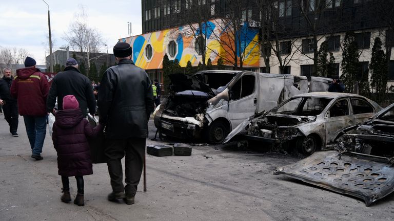 Residents walk past destruction after missile strike in Kyiv