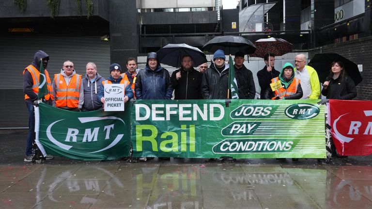 RMT general secretary Mick Lynch (in navy jacket and hood) joins union members on the picket line outside Euston station in London