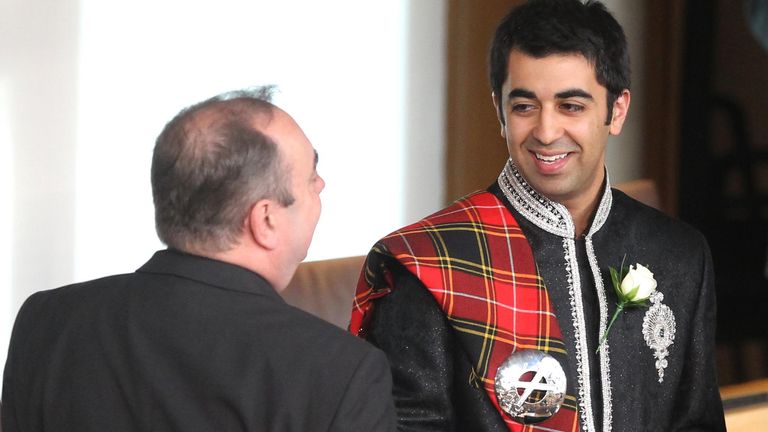 SNP leader Alex Salmond speaks with SNP MSP Humza Yousaf prior to taking the oath of allegiance during the first day of parliamentary business at the Scottish Parliament, Edinburgh.