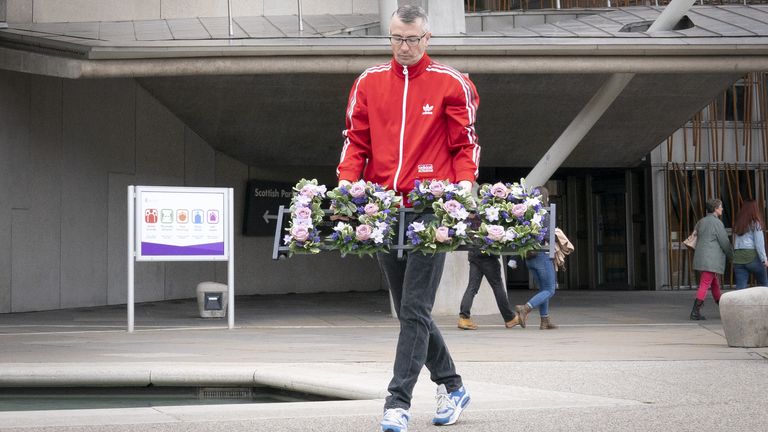 Peter Krykant lays a wreath depicting 1935 the number of overdose deaths in Scotland during a ceremony to mark International Overdose Awareness Day outside the Scottish Parliament, Edinburgh. Picture date: Tuesday August 31, 2021.
