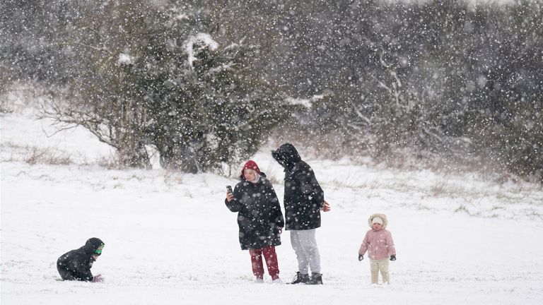 People play in the snow on the Dunstable Downs in Bedfordshire
