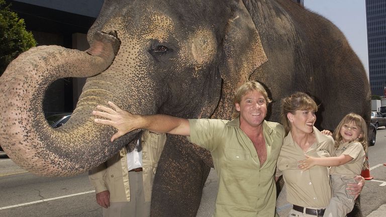 Australian adventurer Steve Irwin and his wife Terri and their daughter Bindi pose with an elephant named Tai at the premiere of the adventure comedy motion picture "The Crocodile Hunter - Collision Course" at the Cinerama Dome in the Hollywood section of Los Angeles June 29, 2002. The naturalist couple appear in the film which opens across the United States on July 12. REUTERS/Jim Ruymen JR