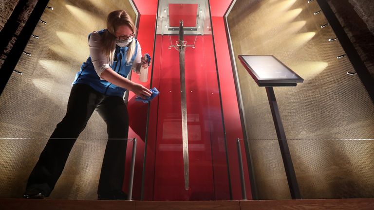 Sally Jeffrey visitor attraction assistant at the Wallace Monument cleans the case which houses William Wallace sword in the Hall of Arms room at the monument near Stirling as they prepare to re-open as Scotland continues with the gradual lifting of restrictions.