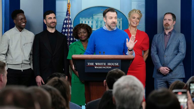 Jason Sudeikis, fourth from left, who plays the title character in the Apple TV+ series ...Ted Lasso..., joins White House press secretary Karine Jean-Pierre, third from left, and fellow cast members, from left, Toheeb Jimoh, Brett Goldstein, Hannah Waddingham, and Brendan Hunt, during the daily press briefing at the White House in Washington, Monday, March 20, 2023. (AP Photo/Susan Walsh)