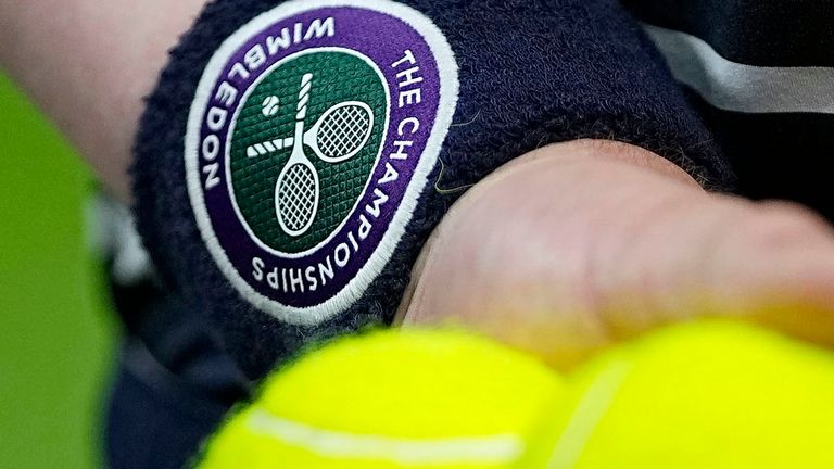 The logo of the Wimbledon tennis championships can be seen on the armband of a ball boy during a match at the tournament in London on June 28, 2022. (Kyodo via AP Images) ==Kyodo