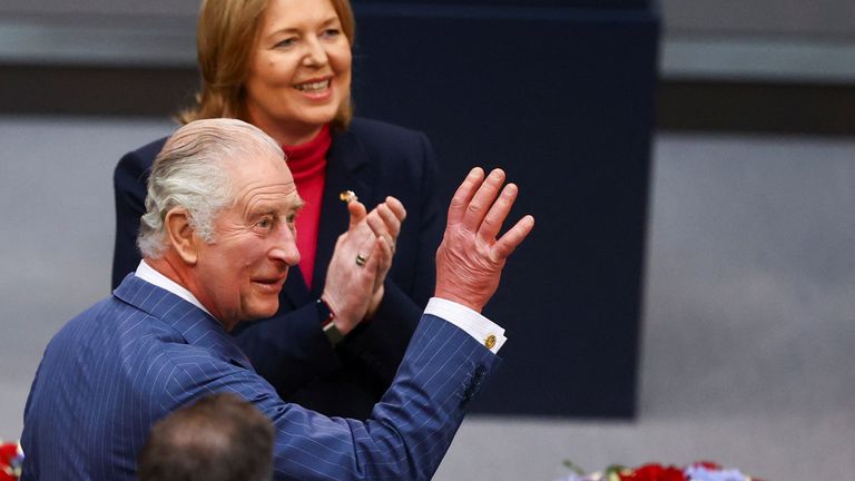The King waves to members of parliament, next to Bundestag president Baerbel Bas