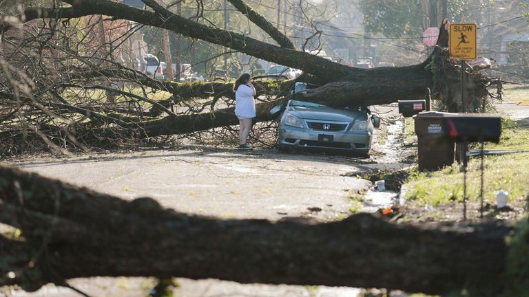 A resident surveys the damage done to her car in Amory, Mississippi. Pic: AP