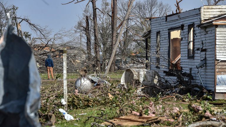 A Silver City, Mississippi, resident stands next to his home Saturday, March 25, 2023, while surveying the surrounding devastation following the deadly tornado that ripped through the state Friday night.  (Clarion-Ledger via AP)