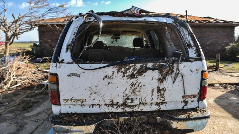 A vehicle and home are seen damaged in Silver City, Miss., Saturday, March 25, 2023, in the aftermath of a tornado that devastated the state the night before. (Hannah Mattix/The Clarion-Ledger via AP)