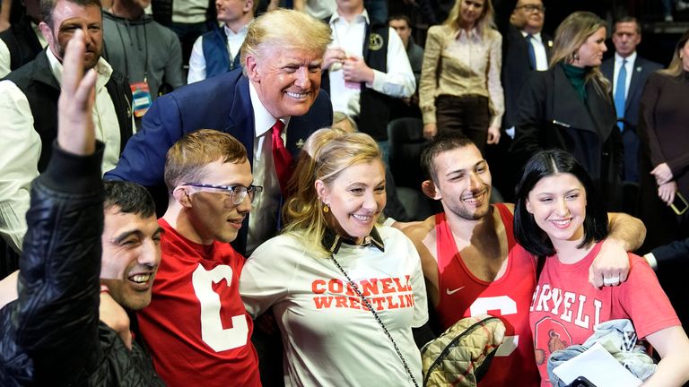 Former President Donald J. Trump and NCAA 133-pound wrestling champion Vito Arucho, second from right, at the NCAA Wrestling Championships Saturday, March 18, 2023 in Tulsa, Oklahoma A group photo with his family.  (AP Photo/Suo Grokey)