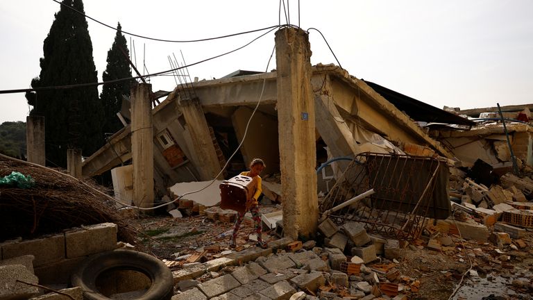 Sabriye Shaymusa, 9, gets stools out of her damaged home for their tent in the aftermath of the deadly earthquake in Bozhoyuk, Turkey