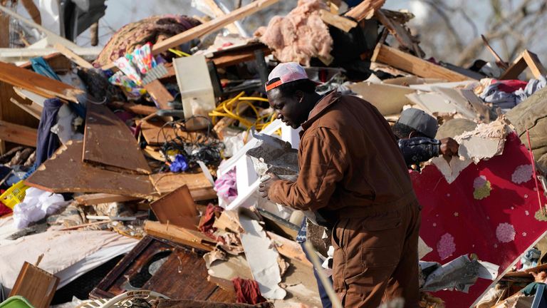 A resident looks through the piles of debris, insulation, and home furnishings to see if anything is salvageable at a mobile home park in Rolling Fork. Pic: AP