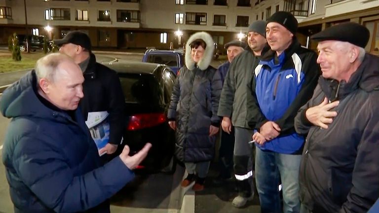 In this photo taken from video released by Russian TV Pool on Sunday, March 19, 2023, Russian President Vladimir Putin talks with local residents during his visit to Mariupol in Russian-controlled Donetsk region, Ukraine. Putin has traveled to Crimea to mark the ninth anniversary of the Black Sea peninsula&#39;s annexation from Ukraine. (Pool Photo via AP)