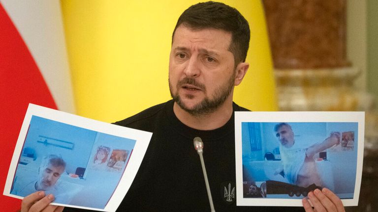 Ukrainian President Volodymyr Zelenskyy shows photos of former Georgian President Mikheil Saakashvili during a joint press conference with Austrian Federal President Alexander Van der Bellen in Kyiv, Ukraine, Wednesday, Feb. 1, 2023. Saakashvili was imprisoned when he returned to Georgia after eight years of exile. Pic: AP