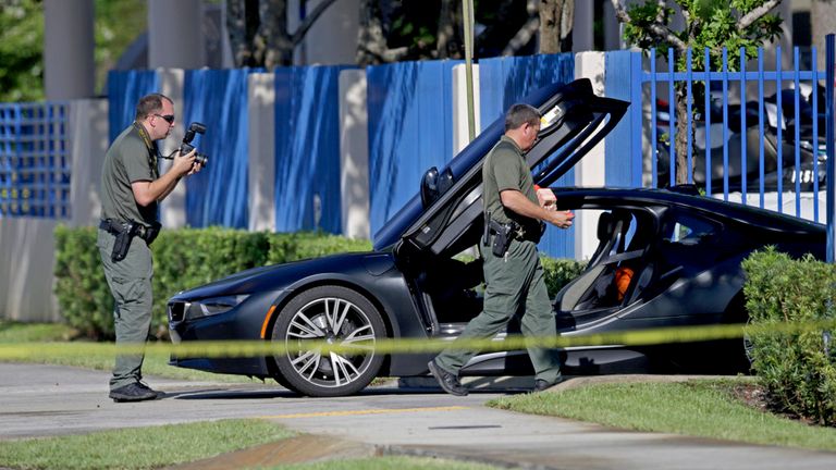Investigators surround a vehicle after rapper XXXTentacion was shot on Monday, June 18, 2018, in Deerfield Beach, Fla. The Broward Sheriff's Office says the 20-year-old rising star was pronounced dead Monday evening at a Fort Lauderdale-area hospital. (John McCall/South Florida Sun-Sentinel via AP)