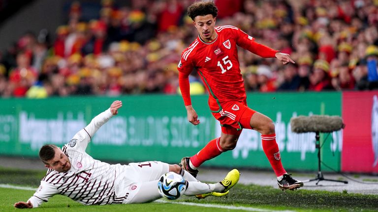 Wales&#39; Ethan Ampadu (right) and Latvia&#39;s Roberts Savalnieks compete for the ball during their Euro 2024 qualifier