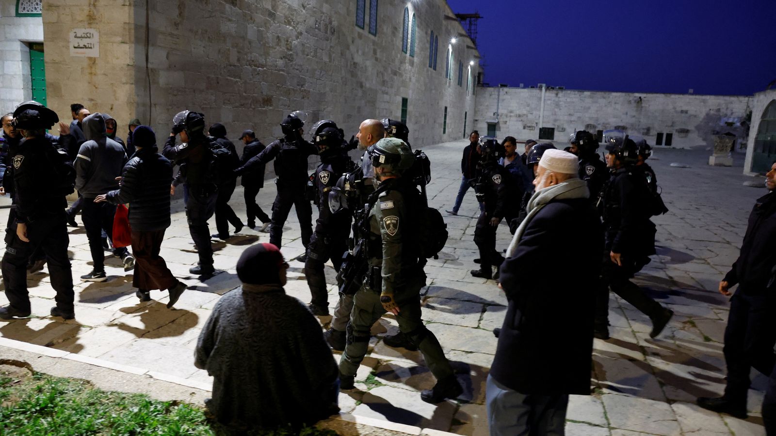 Israeli riot police fire stun grenades and tear gas inside Al Aqsa mosque in clashes with Palestinian worshippers