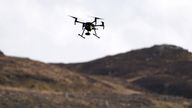 Police Scotland officers use a drone to investigate a remote area of ground at Auchenbreck near Dunoon, Argyll, to find the remains of businesswoman Lynda Spence who was last seen in Glasgow in April 2011. Colin Coats and Philip Wade were both jailed for life in 2013 for the "barbaric" murder of the missing financial adviser. Picture date: Wednesday March 16, 2022.