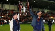 Rob McElhenney and Ryan Reynolds celebrate with the National League trophy