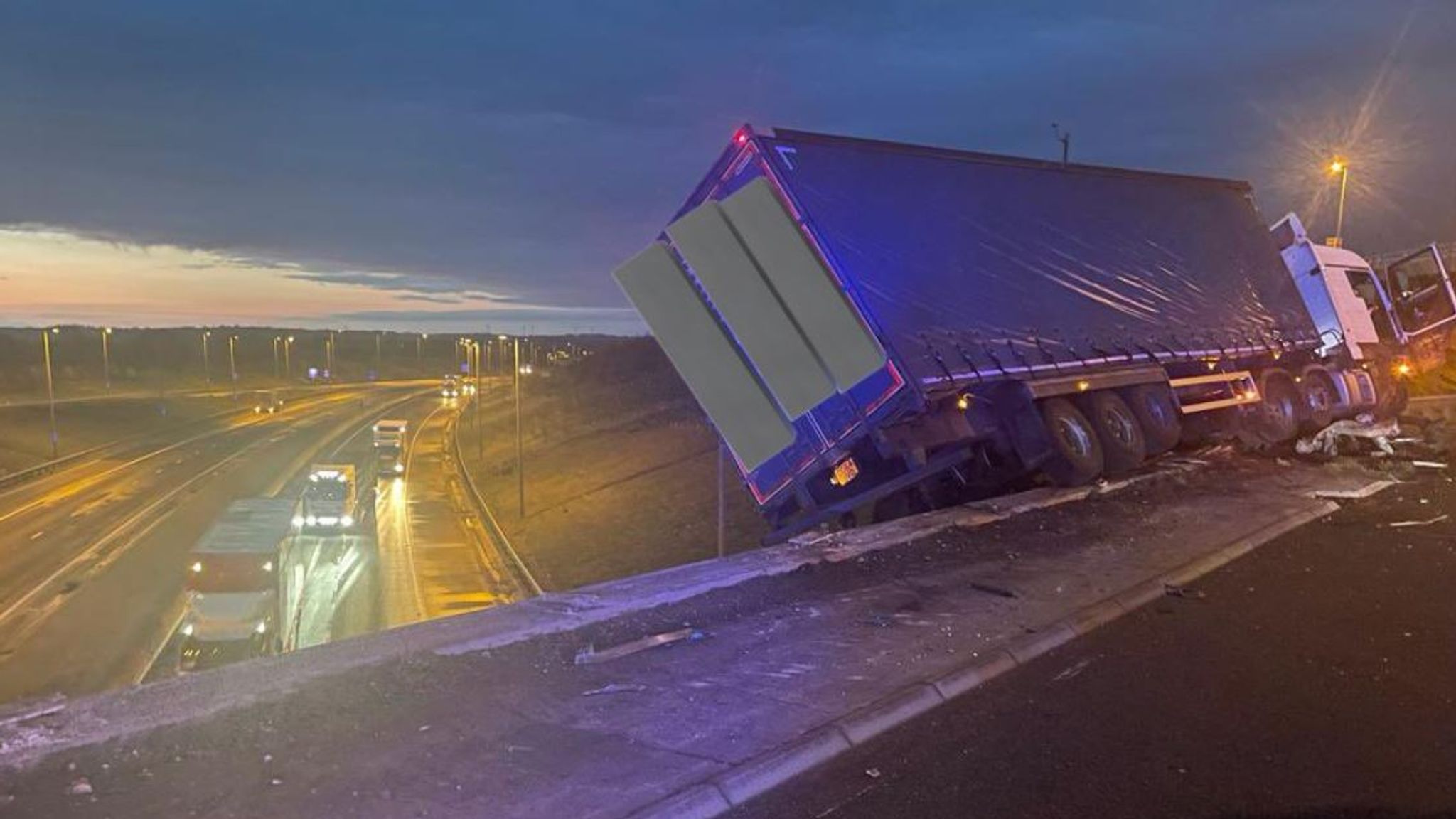 Lorry left hanging off bridge after M1 crash forces closure of