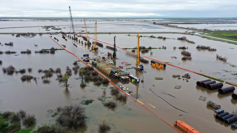 An aerial image shows construction equipment for California High Speed Rail project surrounded by flooding in the Central Valley during a winter storm in Tulare County near Allensworth, California on March 22, 2023 