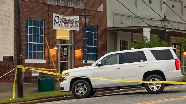 Investigators work at the site of a fatal shooting in downtown Dadevill