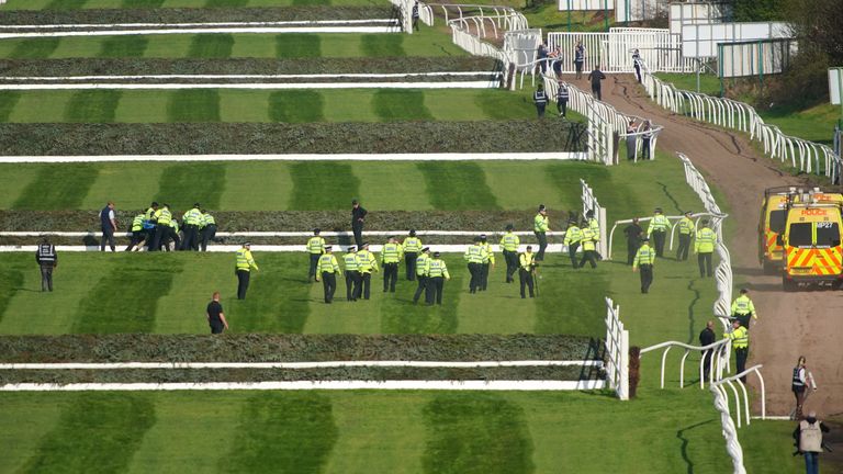 Police officers respond to Animal Rising activists attempting to invade the race course ahead of the Randox Grand National Handicap Chase during day three of the Randox Grand National Festival at Aintree Racecourse, Liverpool. Picture date: Saturday April 15, 2023.