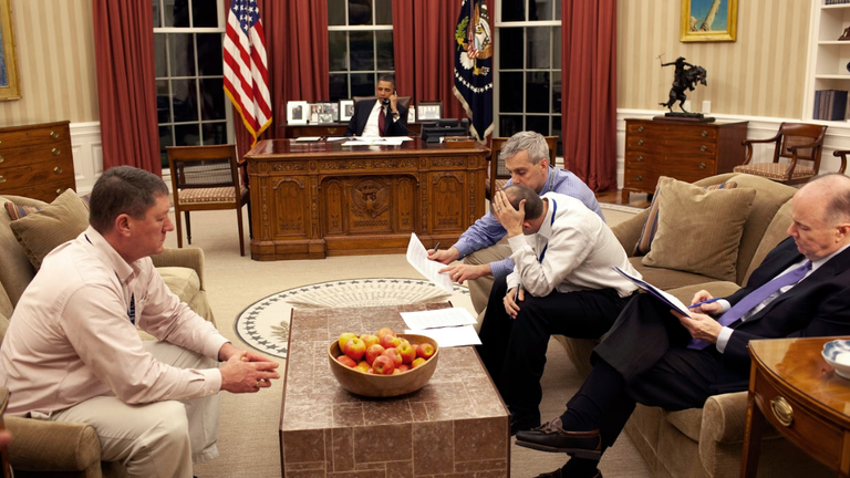 Mr Obama speaks on the phone while his team makes last-minute changes to his speech