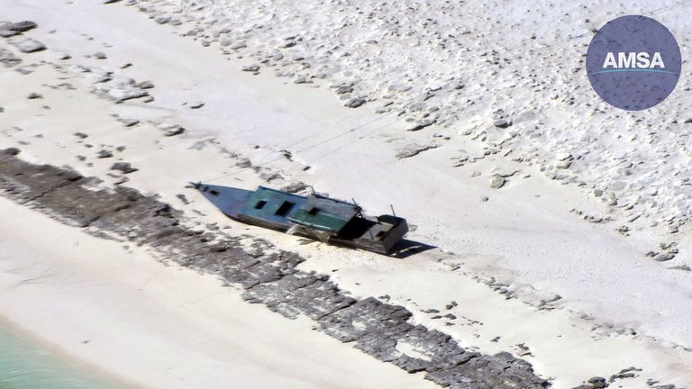 In this photo provided by the Australian Maritime Safety Authority, a fishing boat is beached on Bedwell Island, 313 km (194 miles) west of Broome, Australia, on Monday, April 17, 2023. (Australian Maritime Safety Authority via AP)