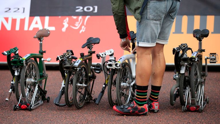 A cyclist prepares to take part in the annual Brompton World Championship Final, held as part of the Prudential RideLondon festival of cycling on The Mall, London.