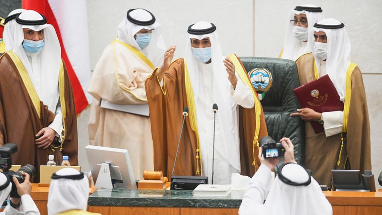 The new Emir of Kuwait Sheikh Nawwaf Al-Ahmad, centre, performs the constitutional oath at the Kuwaiti National Assembly in Kuwait, Wednesday, Sept. 30, 2020. Kuwait...s Sheikh Nawaf Al Ahmad Al Sabah was sworn in Wednesday as the ruling emir of the tiny oil-rich country, propelled to power by the death of his half-brother after a long career in the security services. (AP Photo/Jaber Abdulkhaleg)