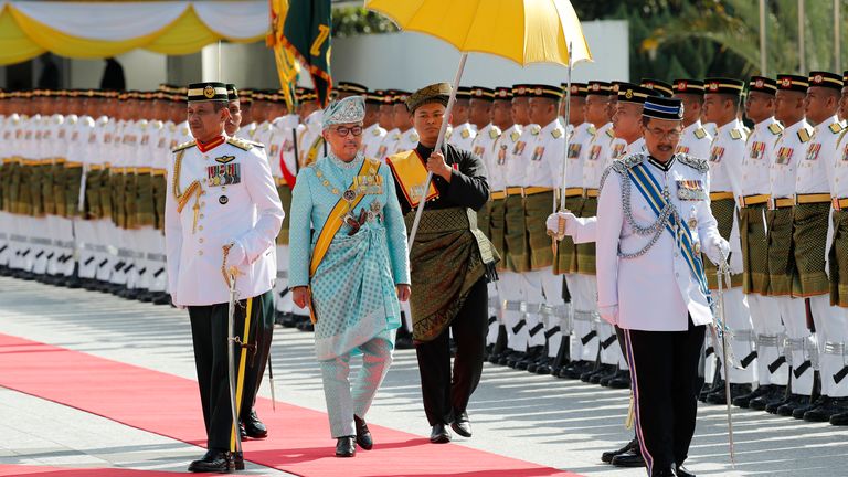 Malaysian new King Sultan Abdullah Sultan Ahmad Shah, second from left, inspects an honor guard during his welcoming ceremony at Parliament House in Kuala Lumpur, Malaysia, Thursday, Jan. 31, 2019. Sultan Abdullah, Ruler of central Pahang state, will be sworn in as Malaysia...s new king after the sudden abdication of Sultan Muhammad V. Malaysia...s nine state rulers take turn to be the country...s king under a rotating monarchy system (AP Photo/Vincent Thian)
