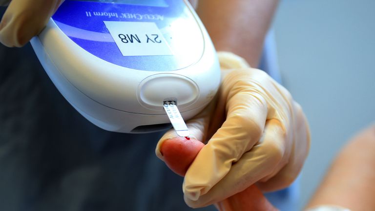 A nurse gives a patient a diabetes test