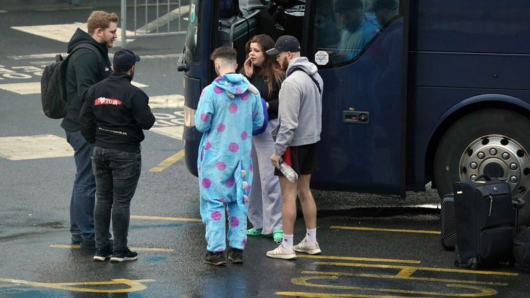 Coach passengers wait in queues