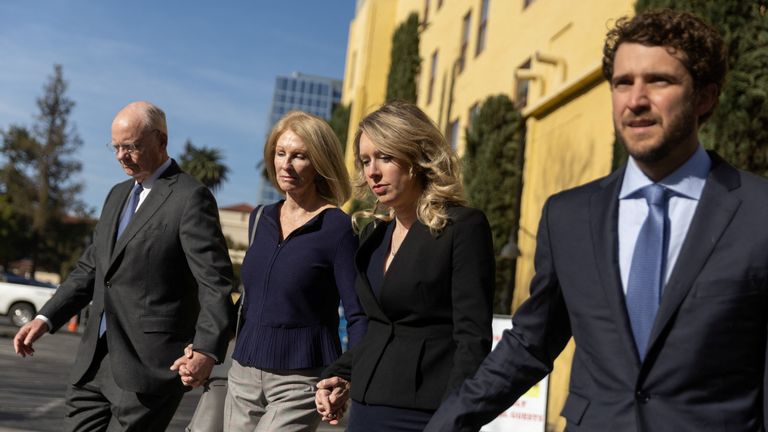 Theranos founder Elizabeth Holmes arrives at the federal courthouse accompanied by members of her family and her partner Billy Evans, to ask a U.S. judge at a hearing to pause her prison sentence of more than 11 years while she urges an appeals court to review her conviction on charges of defrauding investors in the blood testing startup at the federal courthouse in San Jose, California, U.S., March 17, 2023. REUTERS/Carlos Barria
