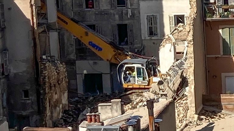 An excavator clears debris on the scene where a building collapsed, in Marseille, southern France, April 10, 2023.Two bodies were found overnight in the rubble following an explosion that collapsed a building in the southern French city of Marseille, as rescuers continued searching for at least six people who are unaccounted-for, authorities said Monday.. (AP Photo/Bishr El Touni)