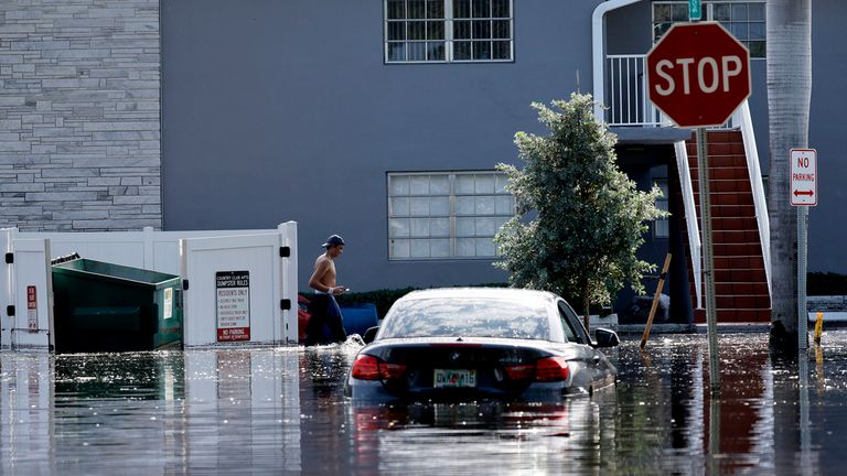 Stalled cars are abandoned on 14th Avenue in Hollywood, Fla., on Thursday, April 13, 2023 after torrential rains flooded areas of South Florida. South Florida has begun draining streets and otherwise cleaning up after an unprecedented storm that dumped upward of 2 feet of rain in a matter of hours. The rains caused widespread flooding, closed the Fort Lauderdale airport and turned thoroughfares into rivers. (Mike Stocker/South Florida Sun-Sentinel via AP)