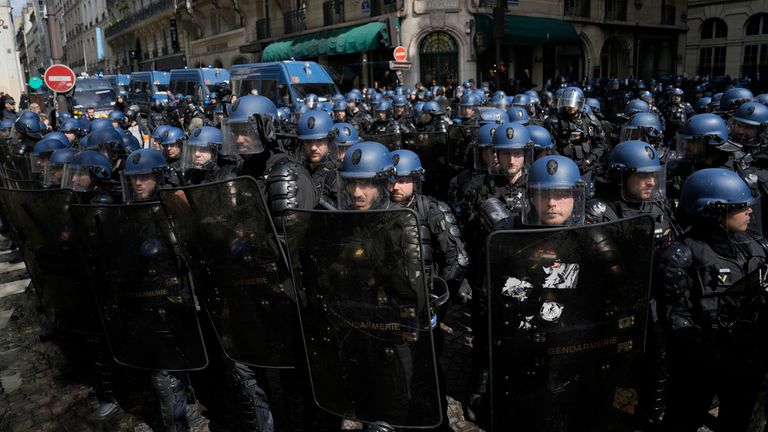 Riot police officers take position during a demonstration, Thursday, April 13, 2023 in Paris. Protesters opposed to President Emmanuel Macron&#39;s unpopular plan to raise the retirement age in France marched Thursday in cities and towns around France in a final show of anger before a decision by the Constitutional Council on whether the measure meets constitutional standards. (AP Photo/Lewis Joly)