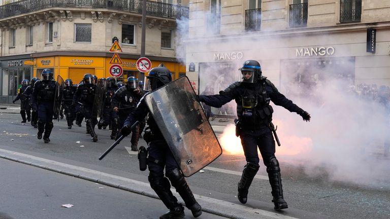 Riot police officers charge youths during a demonstration, Thursday, April 13, 2023 in Paris. Protesters opposed to President Emmanuel Macron&#39;s unpopular plan to raise the retirement age in France marched Thursday in cities and towns around France in a final show of anger before a decision by the Constitutional Council on whether the measure meets constitutional standards. (AP Photo/Thibault Camus)