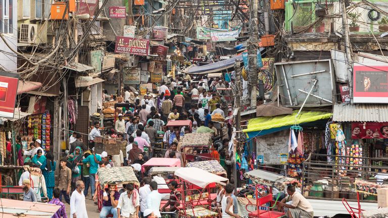 Delhi, India - September 7 2014: Many people and rickshaws move slowly in the very crowded streets of Old Delhi in India.
