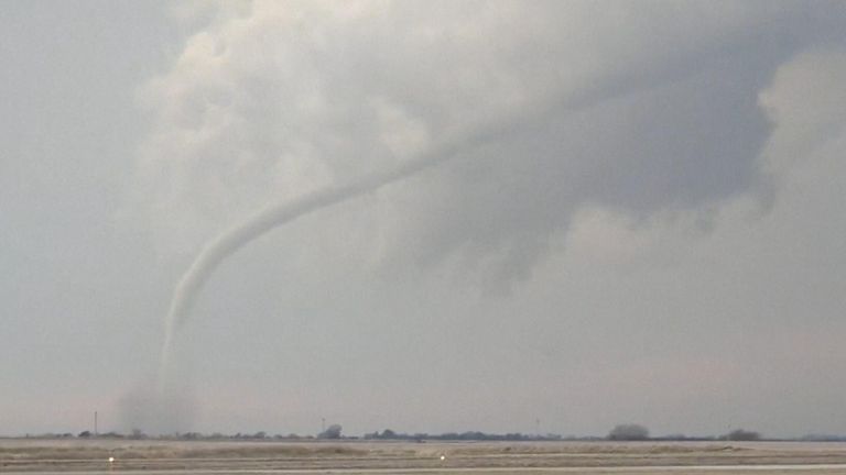  Video recorded in Knoxville, Iowa shows a twister kicking up debris in the distance.