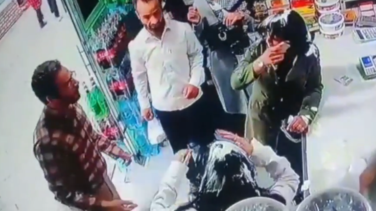 Man throws yoghurt onto heads of women who did not fully cover their hair in Iran.