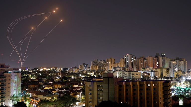 Streaks of light are seen as Israel&#39;s Iron Dome anti-missile system intercept rockets launched from the Gaza Strip