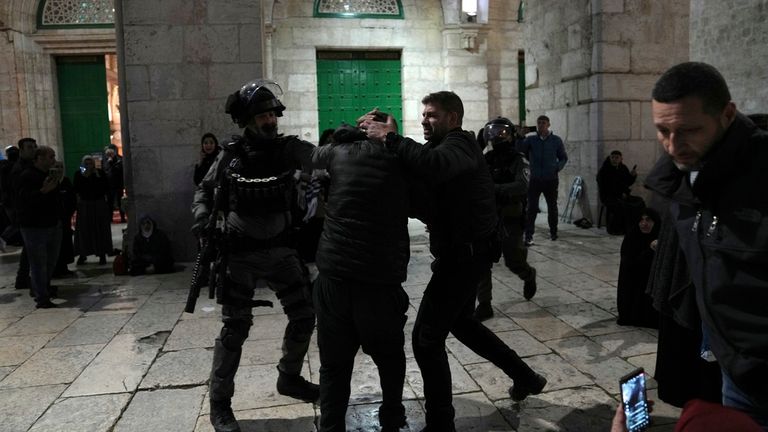 Israeli police detain a Palestinian worshipper at the Al-Aqsa Mosque compound in the Old City of Jerusalem 