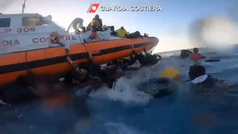 Image released by the Italian coastguard of people being rescued from the sea after trying to reach Europe from Tunisia