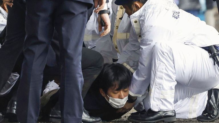 A man was held to the ground by police at the scene. Pic: Kyodo News/AP

A man, on the ground, is caught after what appeared to be a smoke bomb was thrown at a port in Wakayama, western Japan Saturday, April 15, 2023. Japan...s NHK television reported Saturday that a loud explosion occurred at the western Japanese port during Prime Minister Fumio Kishida...s visit, but there were no injuries. (Kyodo News via AP)